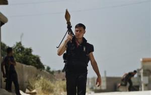 A Free Syrian Army fighter holds a rocket launcher during clashes with Syrian troops near Idlib, Syria, Friday, June 15, 2012.