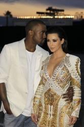 Kanye West whispers about his evil plans to Kim Kardashian at the Cannes Film Festival on May 23, 2012.
