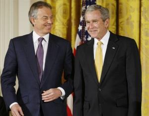 President George W. Bush and former British Prime Minister Tony Blair nudge each other in the East Room of the White House in Washington, Tuesday, Jan. 13, 2009.