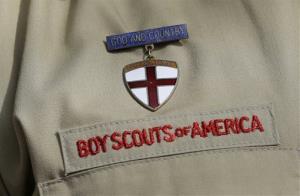 This photo taken  Monday, Feb. 4, 2013, shows a close up detail of a Boy Scout uniform worn by Brad Hankins, a campaign director for Scouts for Equality, as he responds questions during a news conference in front of the Boy Scouts of America headquarters in Irving, Texas. The Boy...